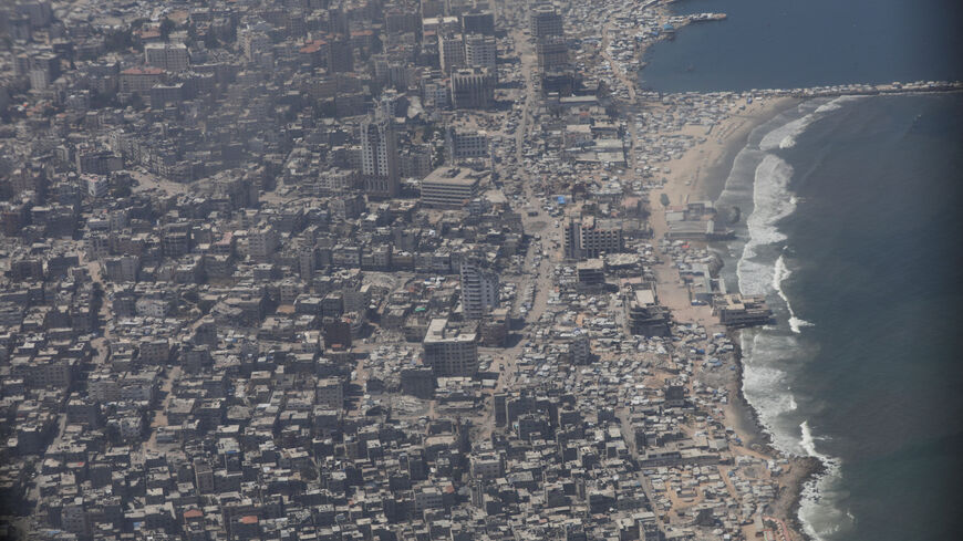 FILE PHOTO: An aerial view from a Jordanian military aircraft shows the Gaza Strip, before humanitarian aid is airdropped over it, in Gaza, August 17, 2025. REUTERS/Alaa Al Sukhni/File Photo