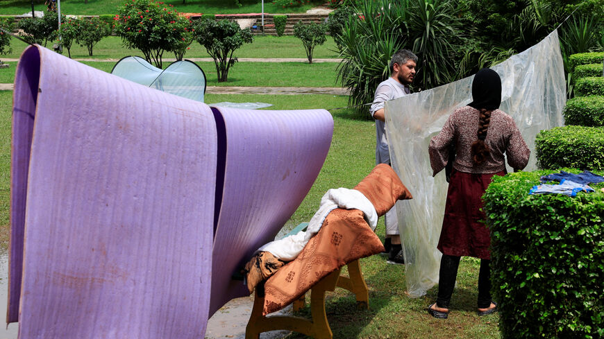 Afghan citizen Haseeb, 30, a tailor, puts a plastic sheet to dry, as he and his family take shelter at a public park after they were evicted, as Pakistan has started to deport documented Afghan refugees ahead of its deadline for them to leave, in Islamabad, Pakistan August 15, 2025. REUTERS/Akhtar Soomro