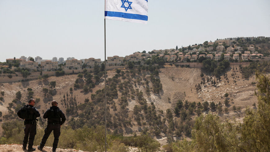 FILE PHOTO: An Israeli flag flutters, as part of the Israeli settlement of Maale Adumim is visible in the background, in the Israeli-occupied West Bank, August 14, 2025. REUTERS/Ronen Zvulun/File Photo