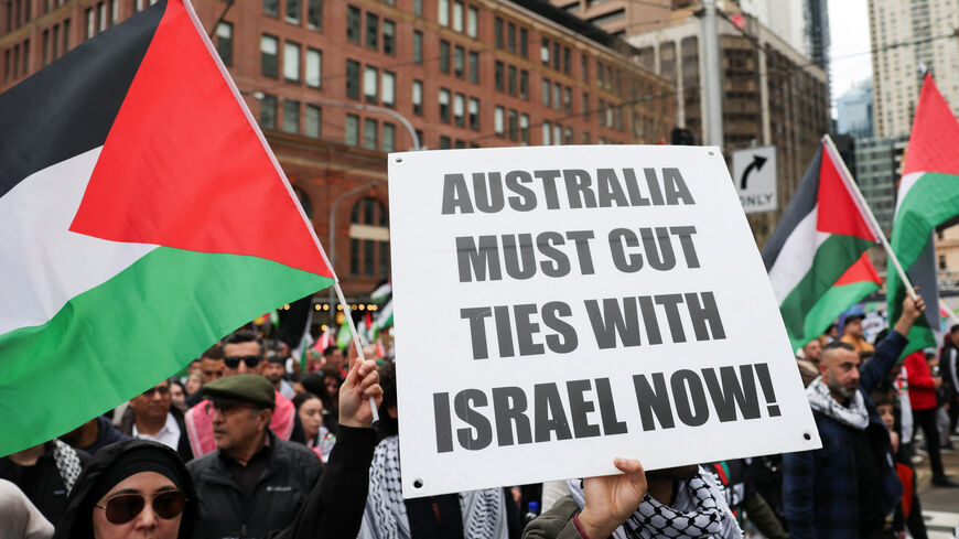 A demonstrators holds a placard as they take part in the 'Nationwide March for Palestine' protest in Sydney, Australia, August 24, 2025. REUTERS/Hollie Adams