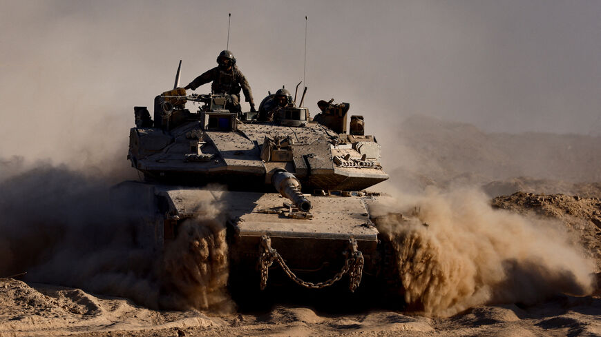 FILE PHOTO: An Israeli tank manouvres at the Israel-Gaza border, as seen from Israel, August 26, 2025. REUTERS/Amir Cohen/File Photo