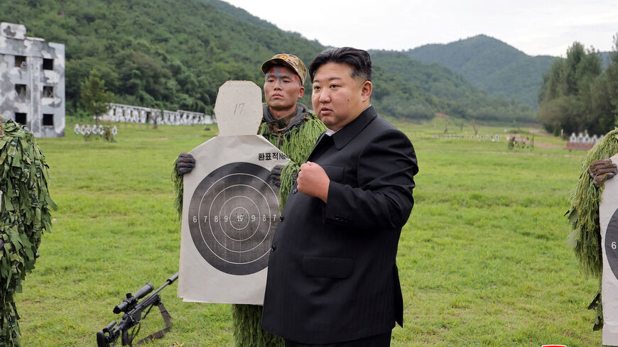 North Korean leader Kim Jong Un reacts while inspecting target sheets during a visit to a special operation training base at an undisclosed location in this undated picture released by North Korea's official Korean Central News Agency August 28, 2025.     KCNA via REUTERS