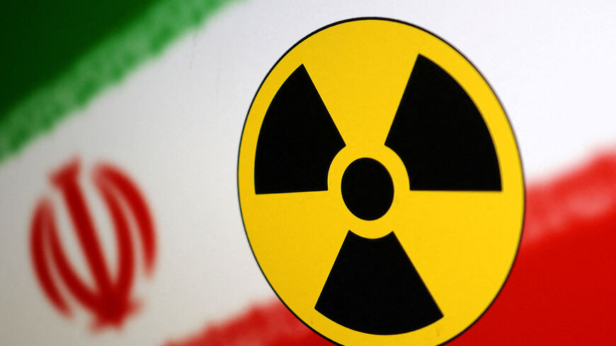 FILE PHOTO: Nuclear symbol and Iran flag are seen in this illustration, July 21, 2022. REUTERS/Dado Ruvic/Illustration/File Photo