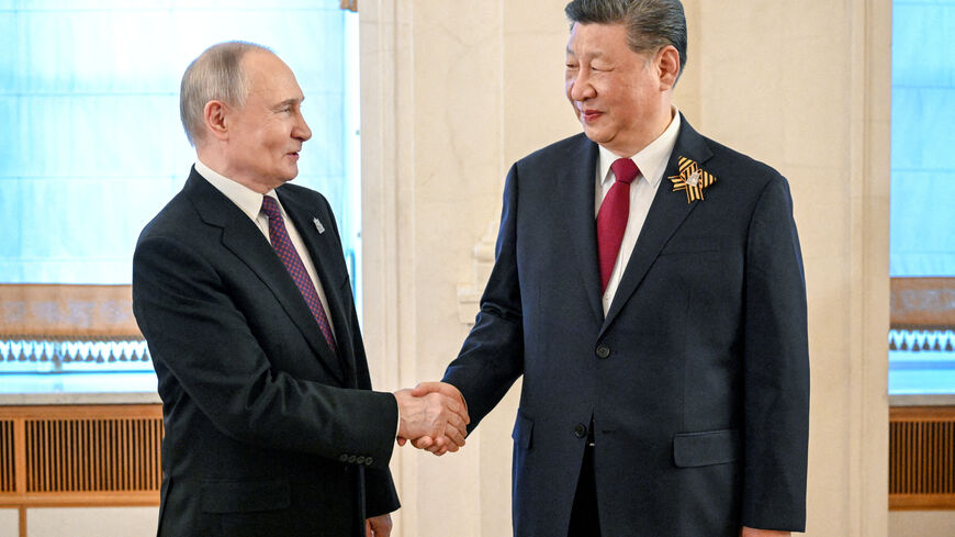 FILE PHOTO: Russian President Vladimir Putin shakes hands with Chinese President Xi Jinping before a festive concert, held on the occasion of the 80th anniversary of the victory over Nazi Germany in World War Two, in Moscow, Russia, May 8, 2025. Sergei Bobylyov/Host agency RIA Novosti/Handout via REUTERS /File Photo