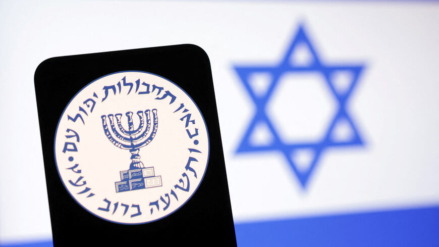 FILE PHOTO: Mossad logo and Israel flag are seen in this illustration taken May 6, 2025. REUTERS/Dado Ruvic/Illustration/ File Photo