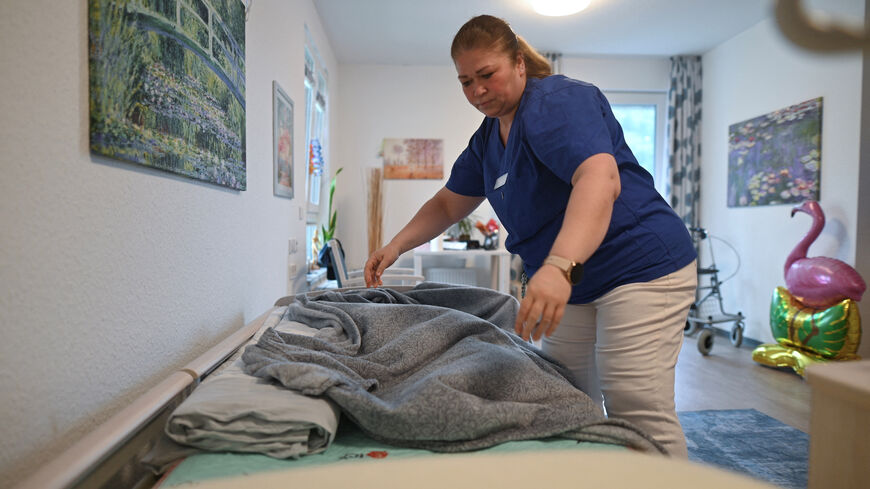 Former Syrian refugee Marwa Alshahal works at a retirement home in Altena, Germany, July 28, 2025. Alshahal was among 100 additional migrants the western German town of Altena volunteered to take in, beyond its federal quota, in an effort to revitalise a shrinking community.  REUTERS/Stephane Nitschke