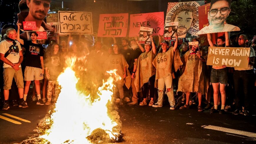 Demonstrators in Tel Aviv call for action to secure the release of hostages held in Gaza, after Palestinian groups released videos of two captives