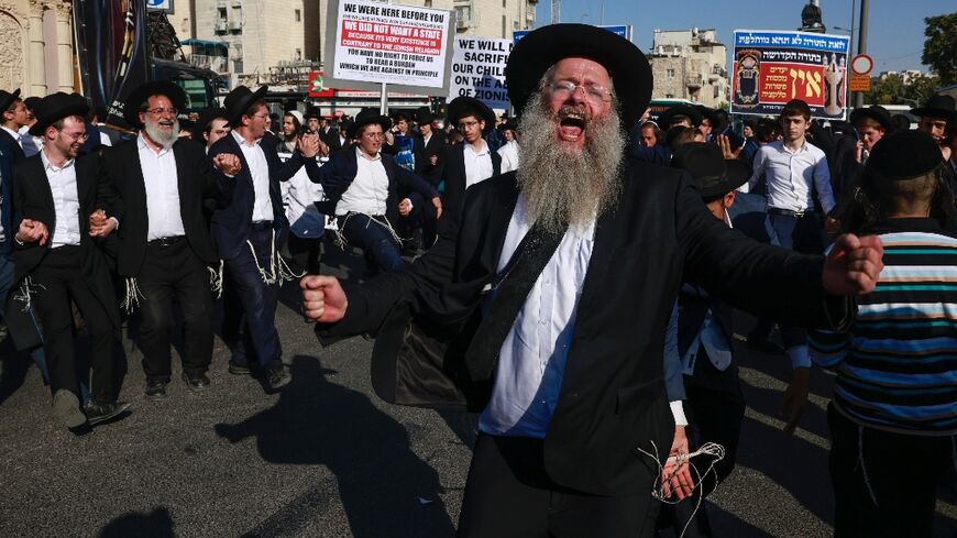 Ultra-Orthodox Jews protest in Jerusalem against the arrest of two brothers for failing to obey their call-up orders after a longstanding exemption for full-time seminary students expired.