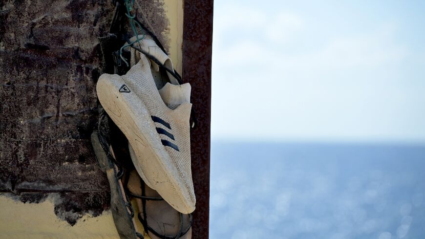 Shoes hanging on the "Porta di Lampedusa" monument, known as "The door of Europe", dedicated to the migrants who have died in the Mediterranean sea trying to reach Europe, on September 25, 2023 on the Italian island of Lampedusa