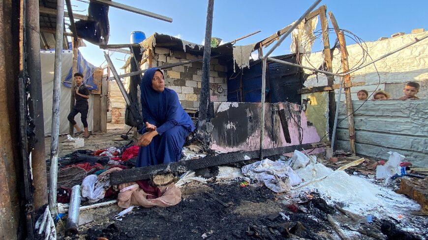 A Palestinian woman at the site of Israeli bombardment on the Al-Mawasi area in the southern Gaza Strip