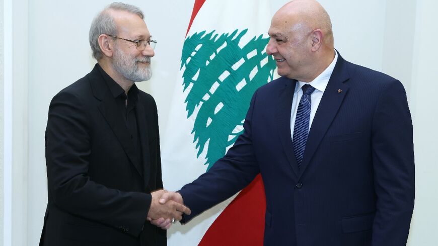 Lebanese President Joseph Aoun (R) shakes hands with Iran's visiting security chief Ali Larijani before telling him he rejects any interference in his country's affairs.