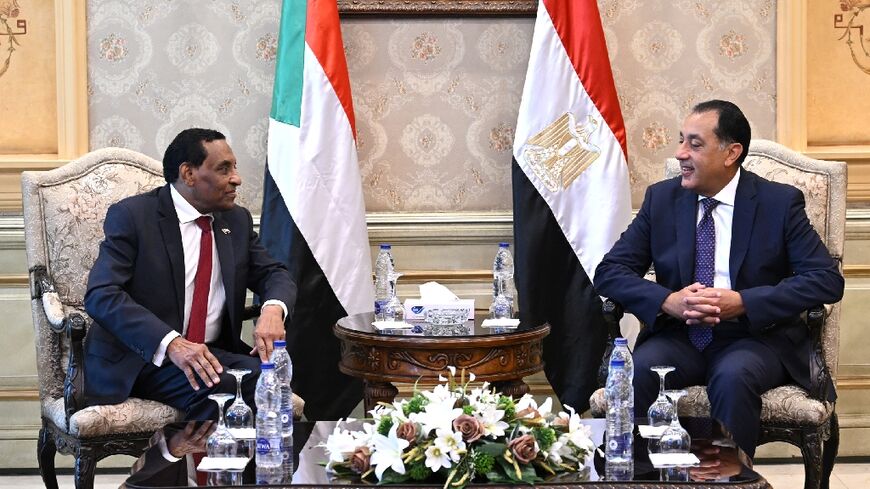 Egypt's Prime Minister Mostafa Madbouly meets with his counterpart from Sudan Kamil Idris upon his arrival in Egypt's capital Cairo
 Sudan's army-aligned prime minister arrived in Cairo on August 7 morning, for his first official foreign visit since assuming office in May, as his country remains gripped by a brutal war, now in its third year.