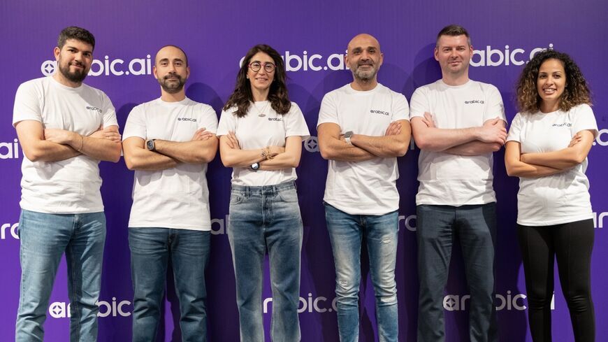 Nour Al Hassan, founder and CEO of Tarjama (C), and members of the Tarjama team promoting Arabic.AI, the firm's new platform offering business solutions in a range of sectors, 2025.