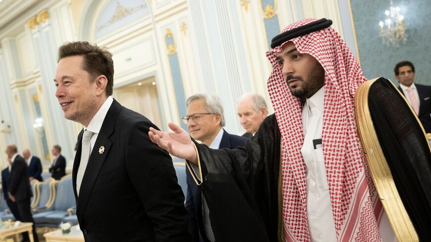 Elon Musk (L) and Nvidia CEO Jensen Huang (C) are directed to greet the Saudi crown prince at the Royal Court in Riyadh, on May 13, 2025. 