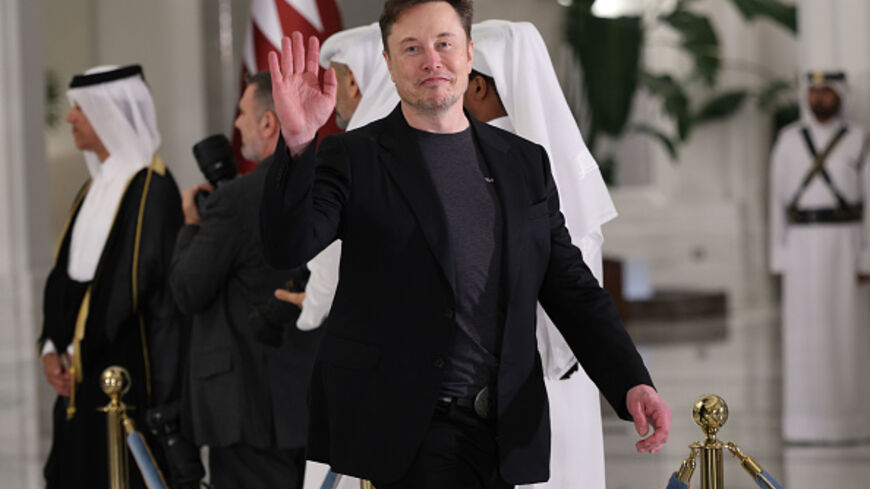 DOHA, QATAR - MAY 14: Elon Musk waves as he arrives for a state dinner at the Lusail Palace on May 14, 2025, in Doha, Qatar. The visit underscores the strategic partnership between the United States and Qatar, focusing on regional security and economic collaboration. (Photo by Win McNamee/Getty Images)