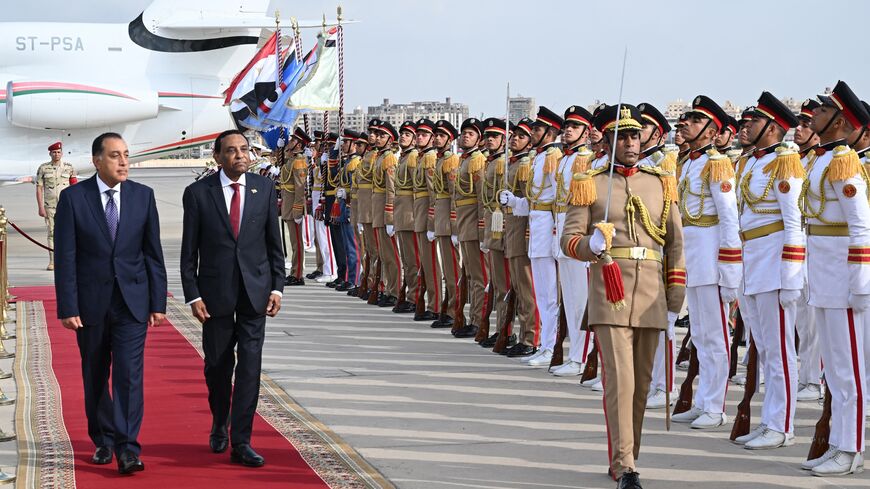 Egypt's prime minister, Mostafa Madbouly (L), welcomes his counterpart from Sudan, Kamil Idris, upon his arrival at the Cairo International Airport in Egypt's capital on Aug. 7, 2025. 