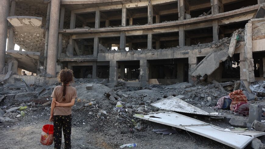 A Palestinian girl at the site of an overnight Israeli strike in Gaza City