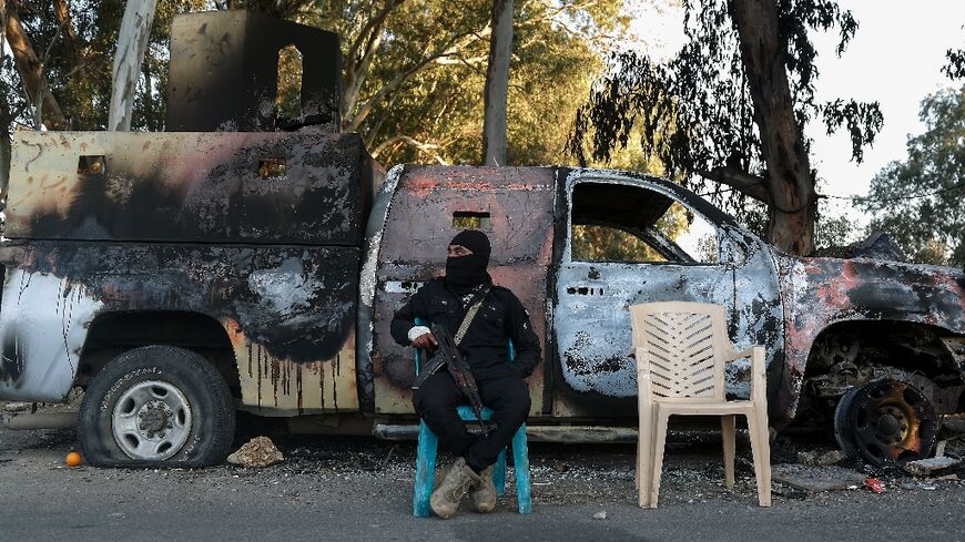 A member of the new Syrian authorities' security forces guards a checkpoint previously held by loyalists to Bashar al-Assad in the coastal province of Latakia in March