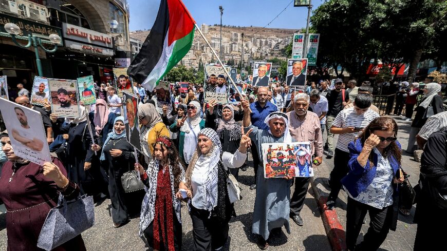 Demonstrators march in the occupied West Bank city of Nablus in solidarity with people in the Gaza Strip and Palestinians held in Israeli prisons