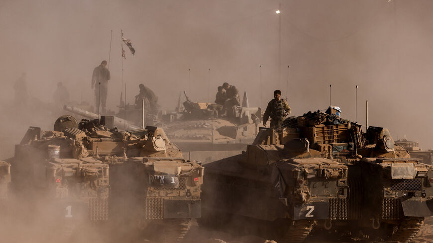 FILE PHOTO: An Israeli soldier stands on top of a military vehicle at the Israel-Gaza border, as seen from Israel, August 26, 2025. REUTERS/Amir Cohen/File Photo