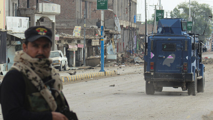 A police officer stands guard on a street with damaged shops in the background, following a militant attack on the Frontier Constabulary (FC) headquarters in Bannu, Khyber Pakhtunkhwa province, in Pakistan September 2, 2025. REUTERS/Ehsan Khattak