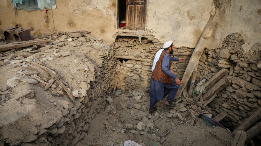 An Afghan man looks for his belongings amidst the rubble of a collapsed house after a deadly magnitude-6 earthquake that struck Afghanistan around midnight, in Dara Noor, in Jalalabad, Afghanistan, September 1, 2025. REUTERS/Sayed Hassib