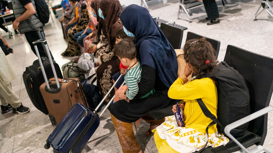 FILE PHOTO: Refugees from Afghanistan wait to be processed after arriving on an evacuation flight at Heathrow Airport, in London, Britain August 26, 2021. Dominic Lipinski/Pool via REUTERS/ File Photo