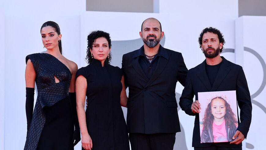 Saja Kilani, Clara Khoury, Amer Hlehel and Motaz Malhees pose on the red carpet with a picture of Hind Rajab during arrivals for the screening "The Voice of Hind Rajab" in competition, at the 82nd Venice Film Festival, Venice, Italy, September 3, 2025. REUTERS/Yara Nardi