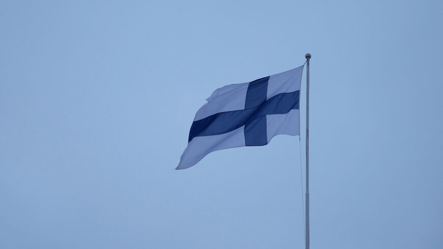 FILE PHOTO: A Finnish flag flies over the City Hall in Helsinki, Finland, February 10, 2024. REUTERS/Tom Little/File photo