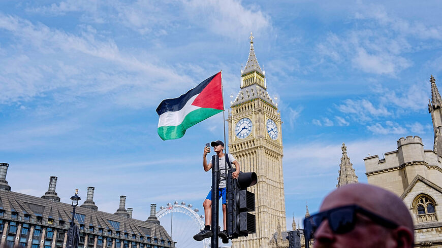 A Palestinian flag is attached to a traffic light on the day of the "Lift The Ban" rally organised by Defend Our Juries, challenging the British government's proscription of "Palestine Action" under anti-terrorism laws, in Parliament Square, in London, Britain, September 6, 2025. REUTERS/Carlos Jasso