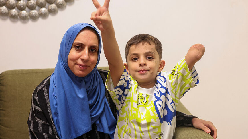 Omar Abu Kuwaik, six-year-old Gazan child who lost an arm, gestures and poses next to his aunt and caretaker, Maha Abu Kuwaik in the apartment where they reside during his medical treatment in Beirut, Lebanon September 4, 2025. REUTERS/Mohamed Azakir