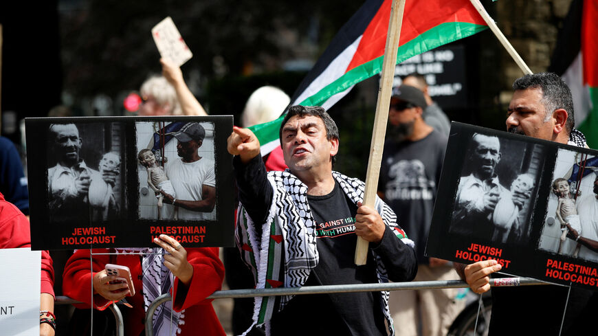 People hold Palestinian flags and signs during a protest outside the screening of the documentary "The Road Between Us: The Ultimate Rescue" about the surprise attack by Hamas on Israel, at the Toronto International Film Festival (TIFF) in Toronto, Ontario, Canada September 10, 2025.  REUTERS/Carlos Osorio