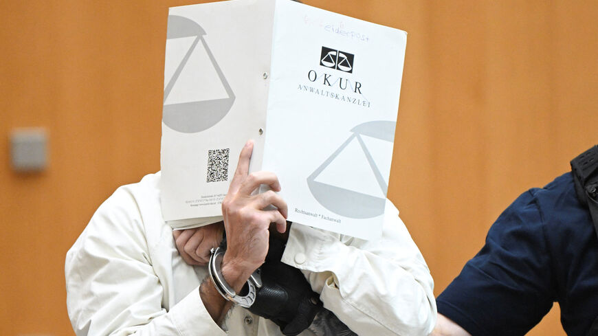 The defendant Sulaiman A arrives at the courtroom of the Higher Regional Court in Stuttgart-Stammheim, Germany, on September 16, 2025, for his trial verdict for murdering a police officer and injureing five others with suspected Islamist motives at an anti-Islam rally at a market square in Mannheim in late May 2024. THOMAS KIENZLE/Pool via REUTERS