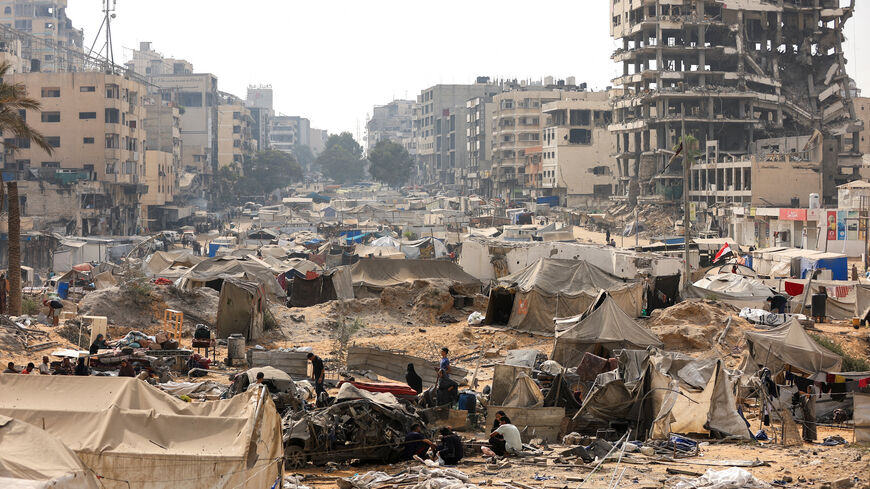 FILE PHOTO: Palestinians inspect a tent camp, which was sheltering displaced people, after it was damaged in an overnight Israeli air strike on a nearby residential building, in Gaza City, September 13, 2025. REUTERS/Dawoud Abu Alkas/File Photo