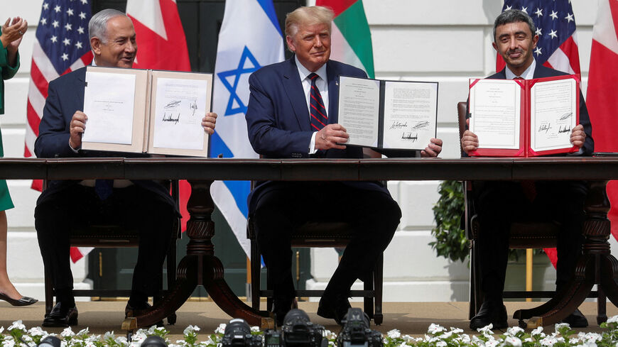 FILE PHOTO: Israel's Prime Minister Benjamin Netanyahu, U.S. President Donald Trump and United Arab Emirates (UAE) Foreign Minister Abdullah bin Zayed display their copies of signed agreements as they participate in the signing ceremony of the Abraham Accords, on the South Lawn of the White House in Washington, U.S., September 15, 2020. REUTERS/Tom Brenner/File Photo