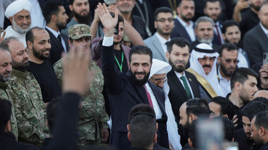FILE PHOTO: Syria’s interim President Ahmed al-Sharaa waves as he attends the “Aleppo, Key to Victory” celebration marking Syria’s liberation, in Aleppo, Syria May 27, 2025. REUTERS/Khalil Ashawi/File Photo