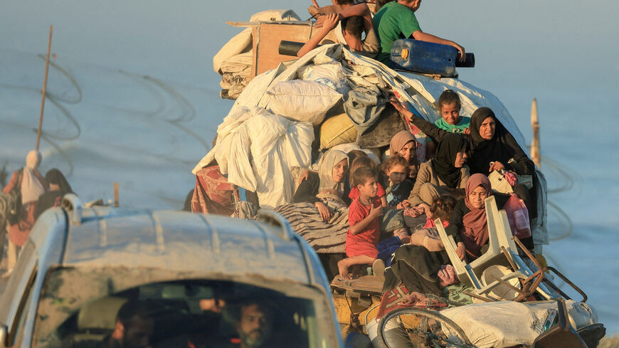 FILE PHOTO: Displaced Palestinians, fleeing northern Gaza due to an Israeli military operation, move southwards after Israeli forces ordered residents of Gaza City to evacuate to the south, in the central Gaza Strip, September 20, 2025. REUTERS/Dawoud Abu Alkas/File Photo