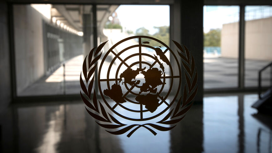 FILE PHOTO: The United Nations logo is seen on a window in an empty hallway at United Nations headquarters in New York, U.S., September 21, 2020. REUTERS/Mike Segar/ File Photo