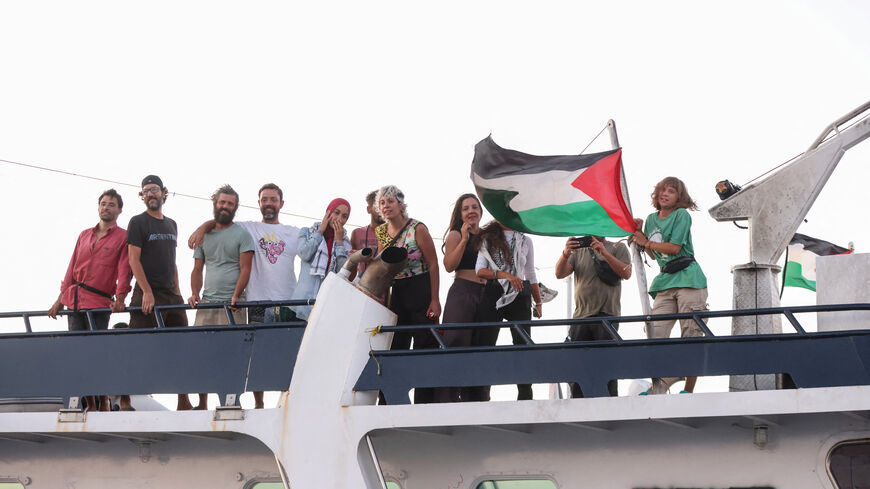Greta Thunberg and members of the crew stand aboard a ship, part of the Global Sumud Flotilla aiming to reach Gaza and break Israel's naval blockade, as they sail off Crete island, Greece, September 25, 2025. REUTERS/Stefanos Rapanis