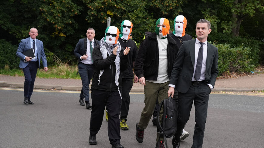 Member of the rap group Kneecap, Liam O'Hanna, also known as Liam Og O hAnnaidh and performing under the name of Mo Chara, who has been charged with a terrorism offence in relation to the alleged display of a Hezbollah flag onstage in 2024, walks outside the Woolwich Crown Court on the day of a hearing, in London, Britain, September 26, 2025. REUTERS/Maja Smiejkowska