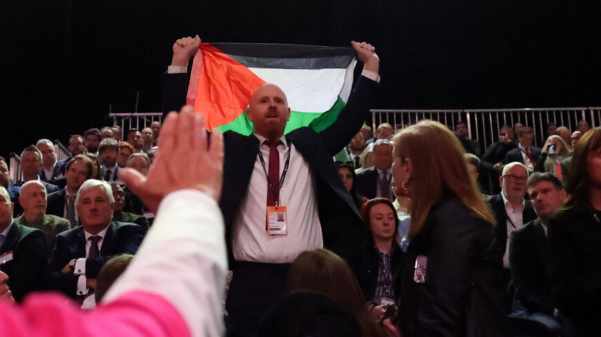 A protester holds up a Palestinian flag, as he disrupts British Chancellor of the Exchequer Rachel Reeves delivering her keynote speech at Britain's Labour Party's annual conference in Liverpool, Britain, September 29, 2025. REUTERS/Hannah McKay