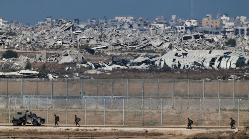 Israeli soldiers walk on the on Israeli side of the Israel-Gaza border, September 30, 2025. REUTERS/Amir Cohen