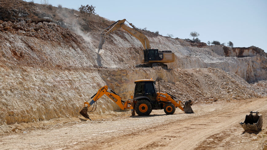 Excavators expand an Israeli bypass road connecting Israeli settlers in the Israeli-occupied West Bank with Jerusalem, near Ramallah in the West Bank, September 29, 2025. REUTERS/Ammar Awad