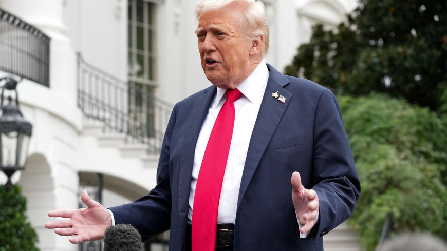 U.S. President Donald Trump speaks to the press before boarding Marine One to depart for Quantico, Virginia, from the South Lawn at the White House in Washington, D.C., U.S., September 30, 2025. REUTERS/Ken Cedeno