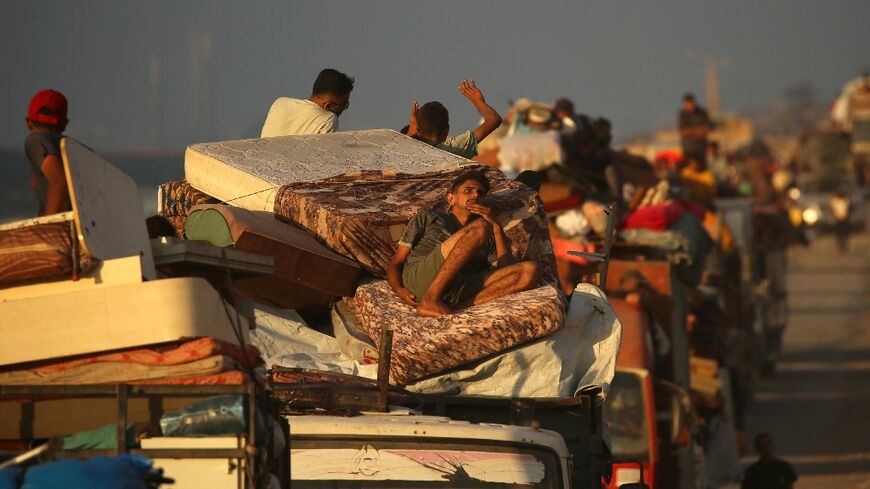 Displaced Palestinians move southwards on a road in the central Gaza Strip, as Israel presses its assault on Gaza City