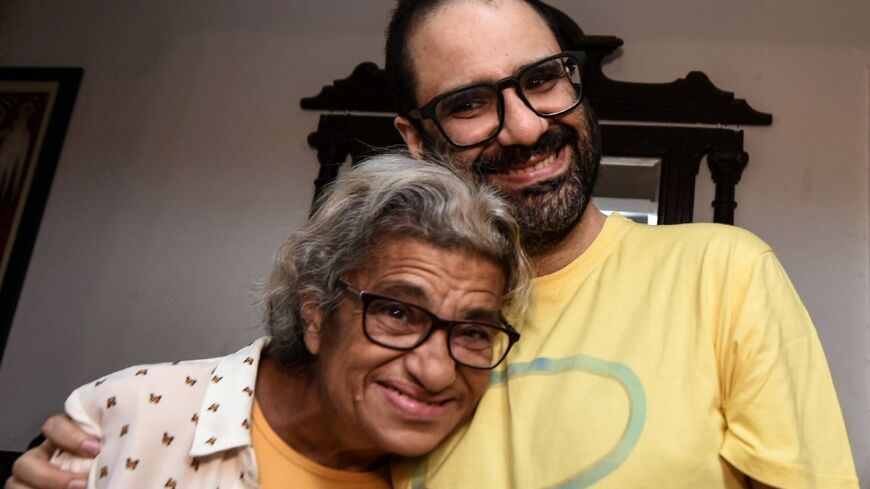 British-Egyptian activist Alaa Abdel Fattah embraces his mother Laila Soueif