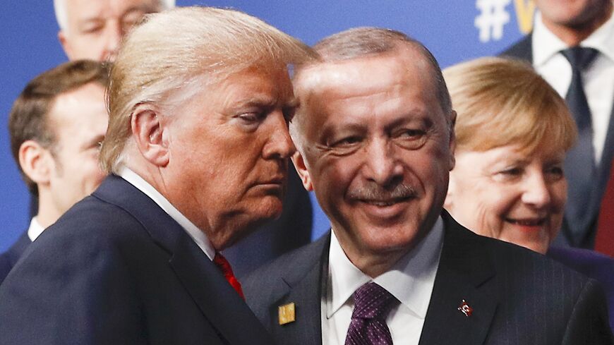 US President Donald Trump (L) and Turkey's President Recep Tayyip Erdogan (R) leave the stage after the family photo to head to the plenary session at the NATO summit at the Grove hotel in Watford, northeast of London.