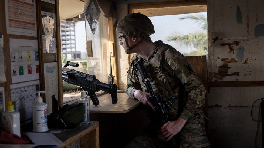 BAGHDAD, IRAQ - MAY 30: A U.S. Army soldier looks onto Baghdad from a guardhouse on the perimeter of the International Zone on May 30, 2021 in Baghdad, Iraq. Coalition forces based in Baghdad's International Zone are part of the U.S.-led Military Advisor Group of 13 nations supporting the Iraqi Security Forces. The United States currently maintains 2,500 military personnel in Iraq as part of Operation Inherent Resolve. Alpha Company 769th brigade Engineer Battalion, Louisiana National Guard is providing for