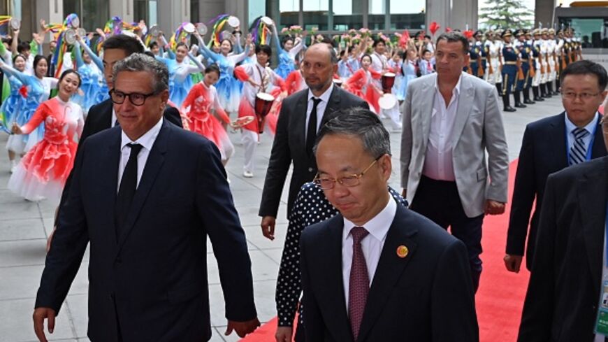 Morocco Prime Minister Aziz Akhannouch (L) walks with officials upon arriving at the Beijing Capital International airport in Beijing on September 4, 2024. (ADEK BERRYADEK BERRY/AFP via Getty Images)