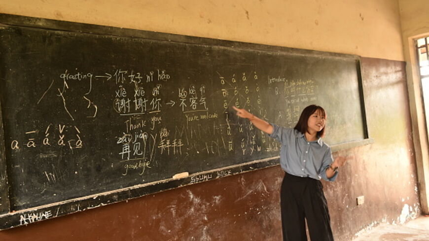 Mandarin language teacher Liu Mei gestures a the blackboard at the Confucius Institute in Sierra Leone during a class for students of the Fourah Bay College Secondary School in Freetown on October 15, 2024. The Chinese language and martial arts teachings are becoming popular amongst school children in several school institutions in Freetown and at the Fourah Bay College Secondary School since it was established in the country in 2012 to promote people to people traditional and cultural exchanges and for dee